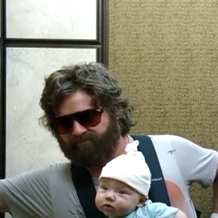 Zach Galifianakis holding a baby, Bradley Cooper with a hand on his face, and Ed Helms inspecting tissue, scene from "The Hangover" movie in an elevator