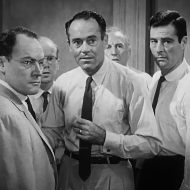 The image shows actors from the classic film "12 Angry Men" in an intense scene, including Henry Fonda and other cast members in a deliberation room