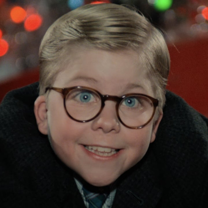 Child character, Ralphie Parker, from "A Christmas Story" with glasses and a wide smile, wearing a winter coat