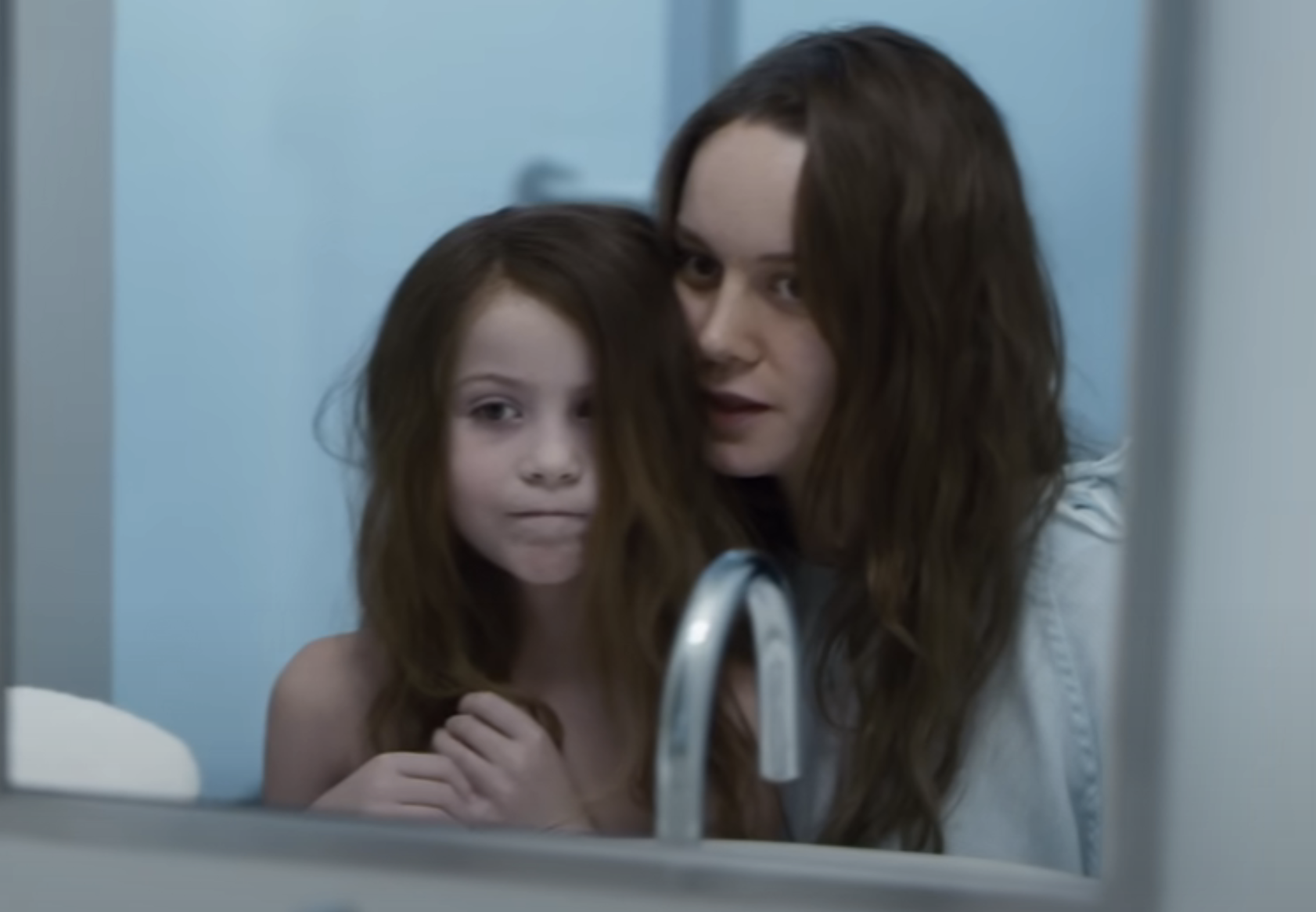 Brie Larson and Jacob Tremblay look at a mirror in a scene from Room