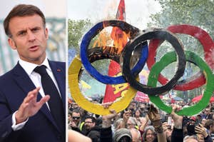 Emmanuel Macron gestures while protesters burn a paper model of Olympic rings during a demonstration