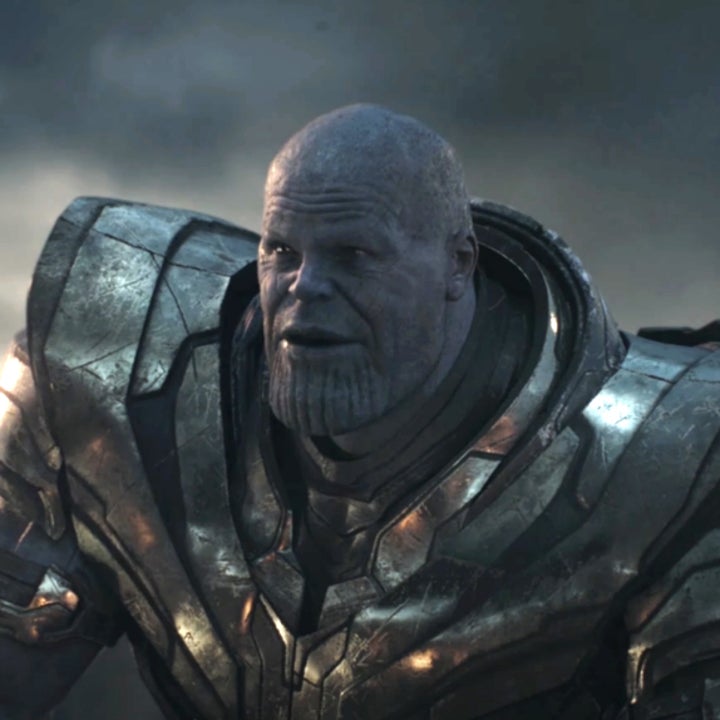 Thanos, wearing battle armor and holding a sword, stands in a battlefield scene from the film Avengers: Endgame