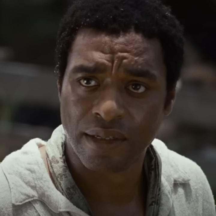 Chiwetel Ejiofor in a scene from 12 Years a Slave, wearing a worn white shirt, looking intently
