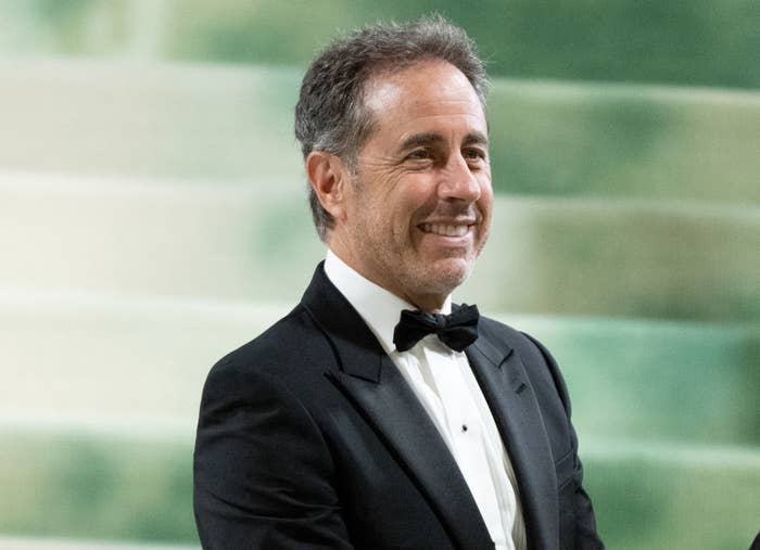 Jerry Seinfeld in a black tuxedo and bow tie, smiling