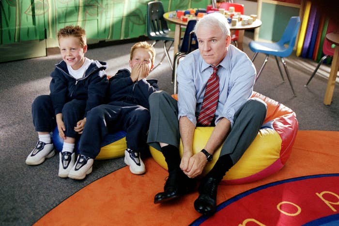 Steve Martin in a scene from &quot;Cheaper by the Dozen,&quot; sitting on a beanbag next to twins Brent and Shane Kinsman, who are also seated and giggling