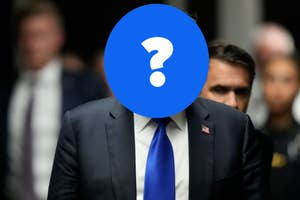 Donald Trump in a suit and tie walks with a group of people in the background, his face is obscured by a blue circle with a question mark