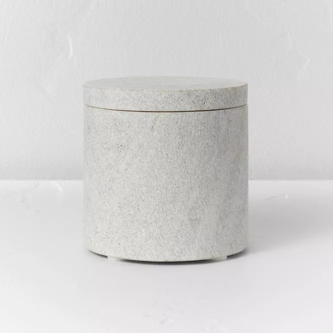 Round concrete canister with a matching lid on a white background, suitable for home storage or decor