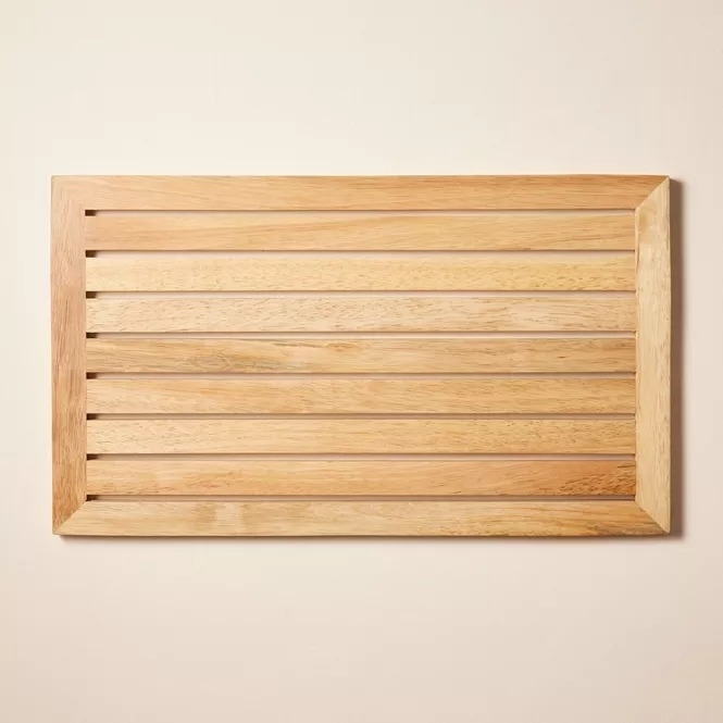 A wooden slatted bath mat, ideal for adding a natural touch to bathroom decor