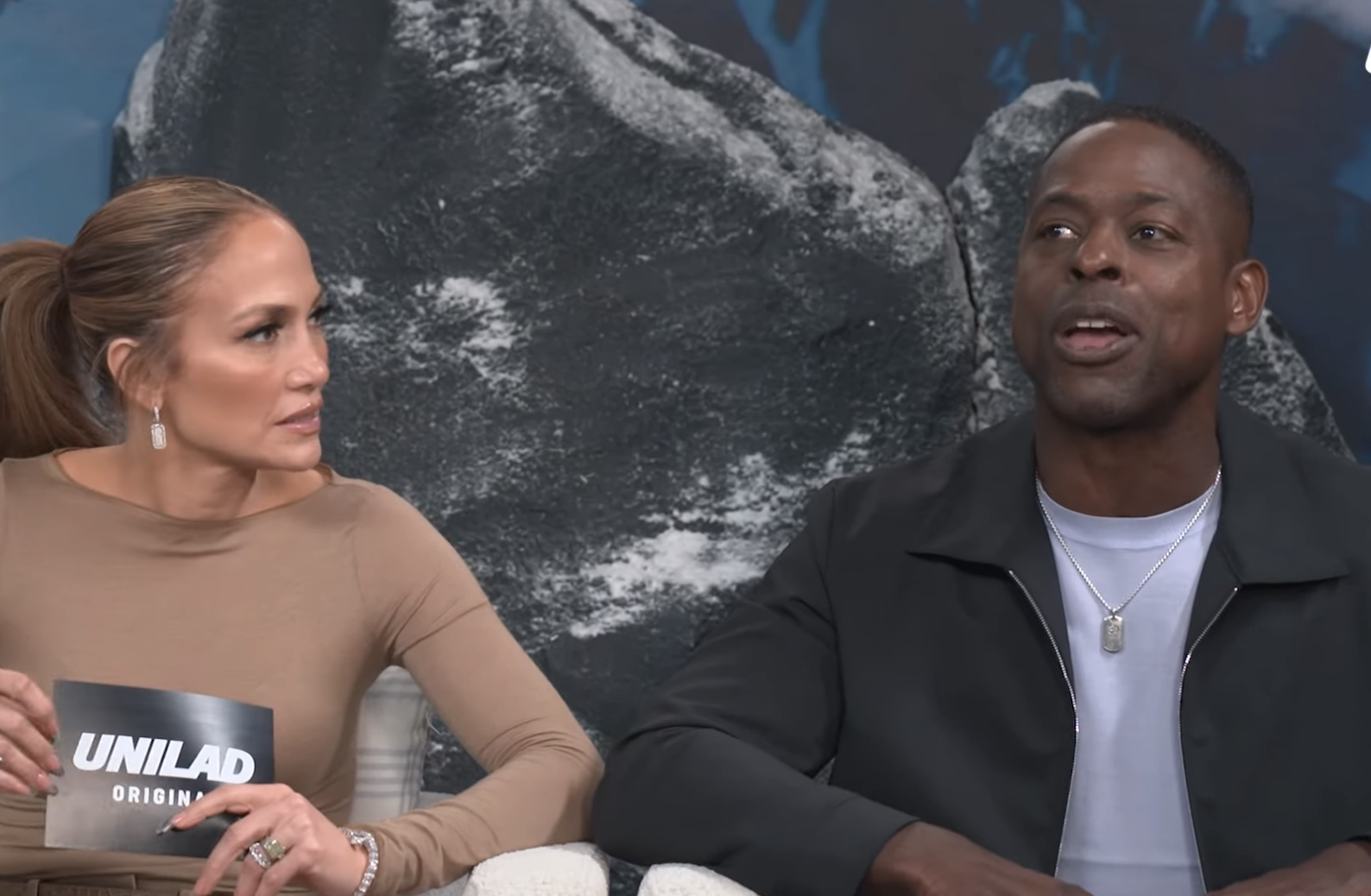Jennifer Lopez, Simu Liu, Sterling K. Brown, and Atlas Robot from Boston Dynamics discussing AI fears in a YouTube video titled "Unilad - In The Vault."