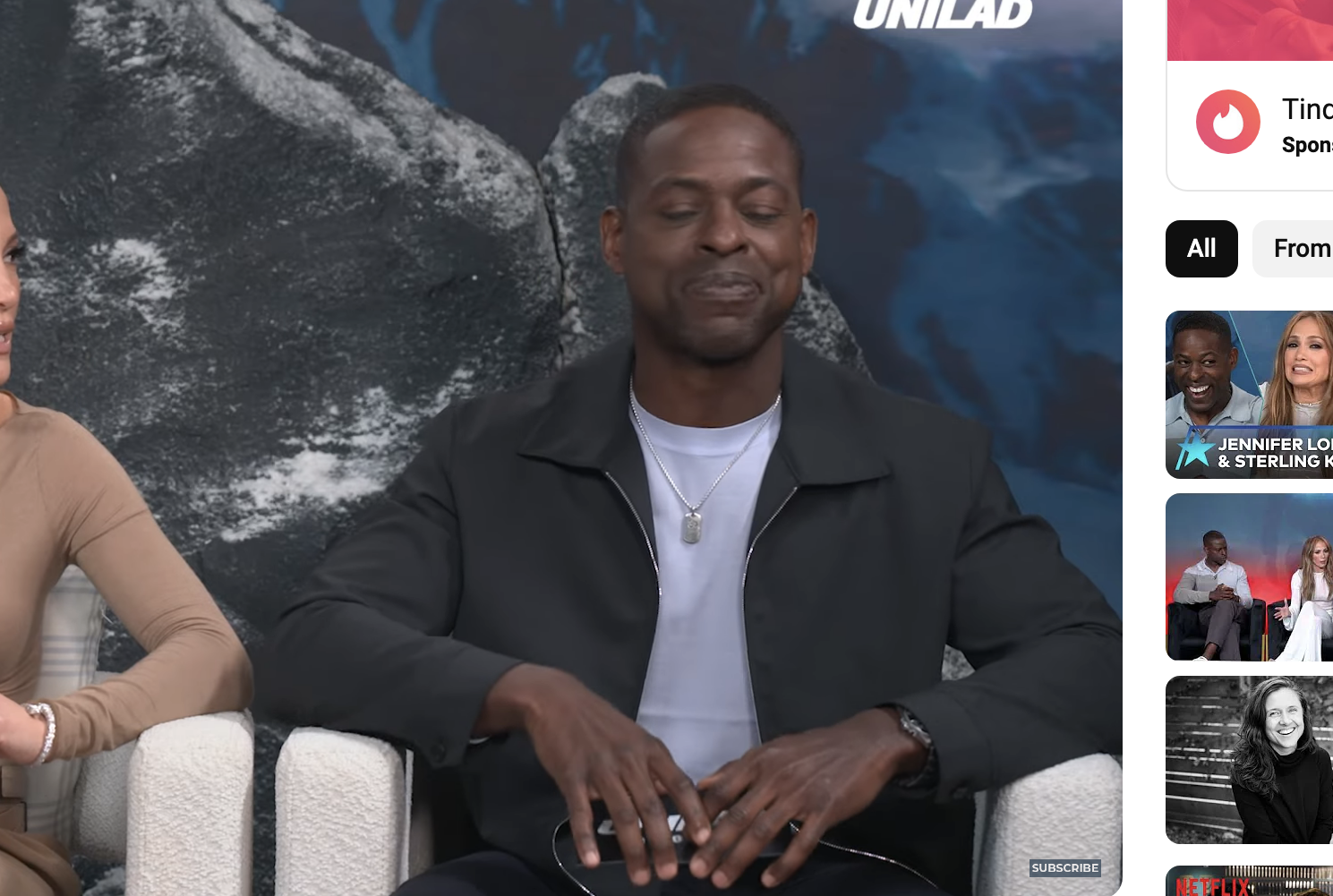 Jennifer Lopez, Simu Liu, and Sterling K. Brown are seated, discussing A.I. related fears in a YouTube video by Unilad