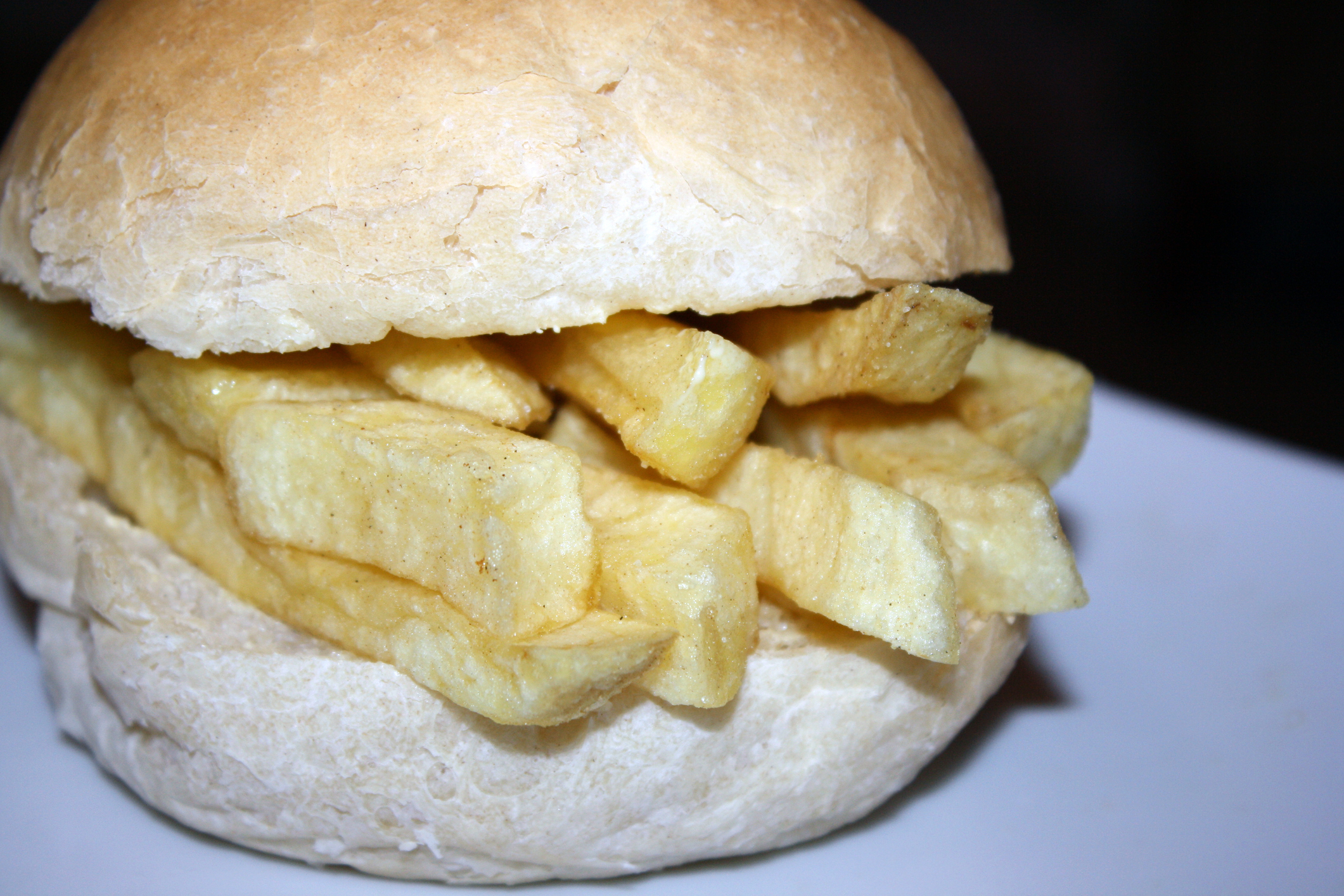 A sandwich bun filled with thick-cut french fries