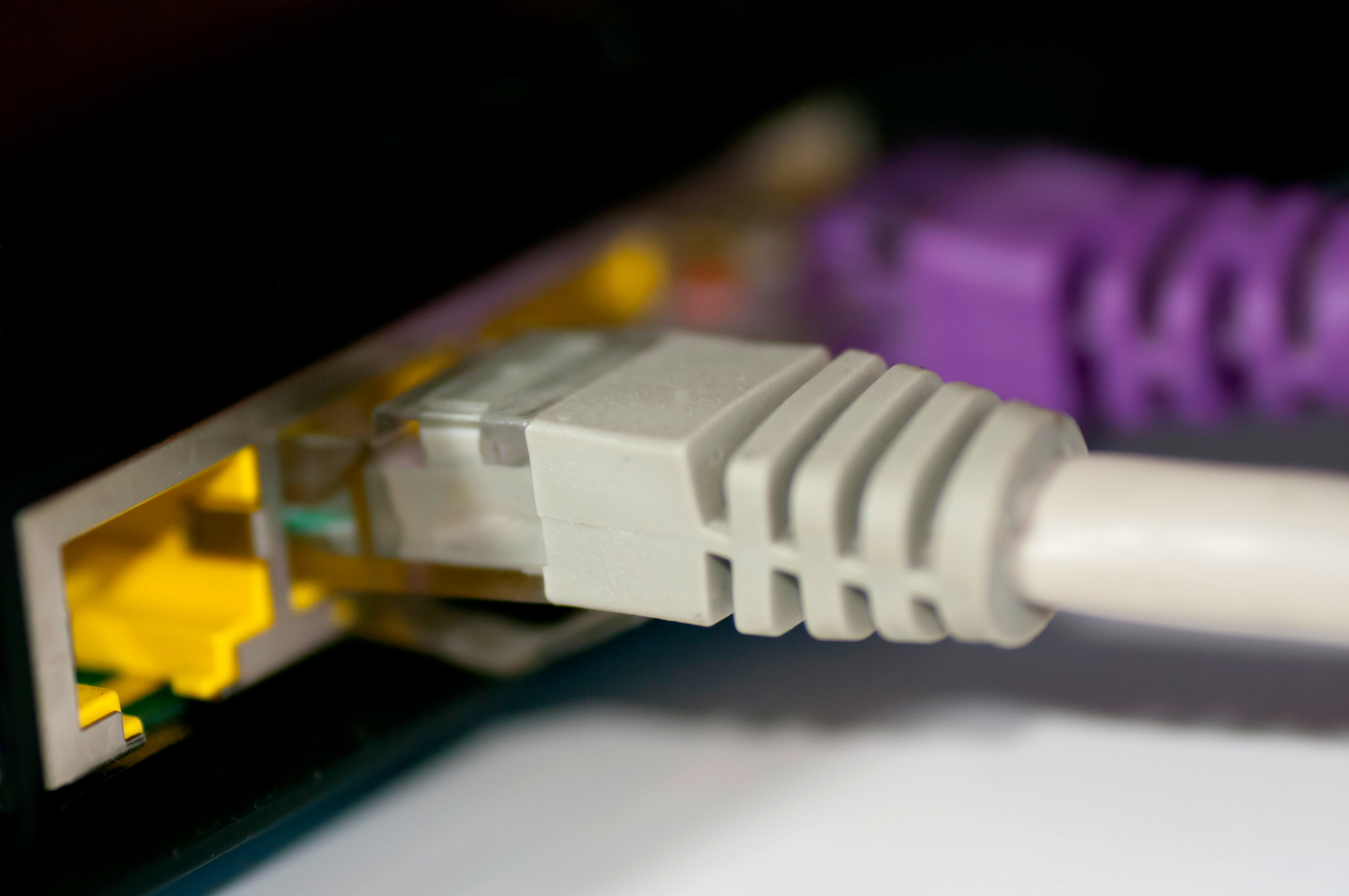 Close-up image of an Ethernet cable plugged into a network port, signifying internet connectivity