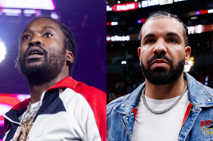 Meek Mill and Drake at a public event. Meek Mill is wearing a sporty jacket with chains and Drake is in a denim jacket with a beaded chain
