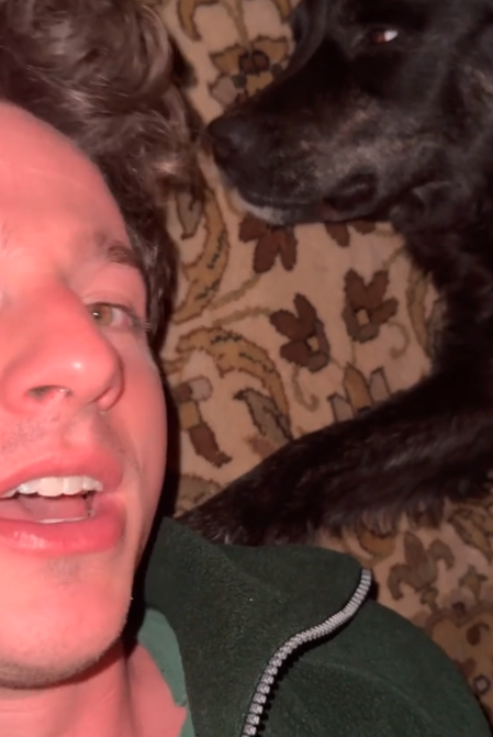 Closeup of Charlie Puth next to his dog