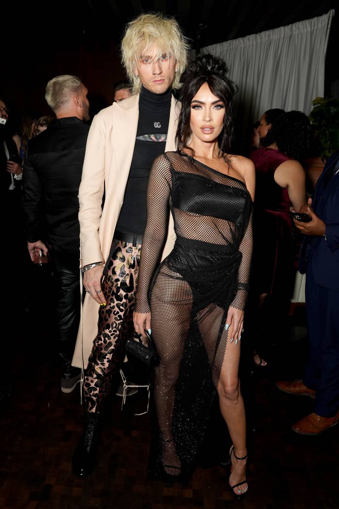 Megan Fox in a sheer mesh dress with Machine Gun Kelly in a leopard print pant and beige jacket