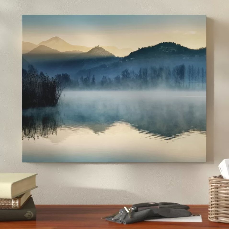 Wall art featuring a serene lake with mist and layered mountains, ideal for home decor