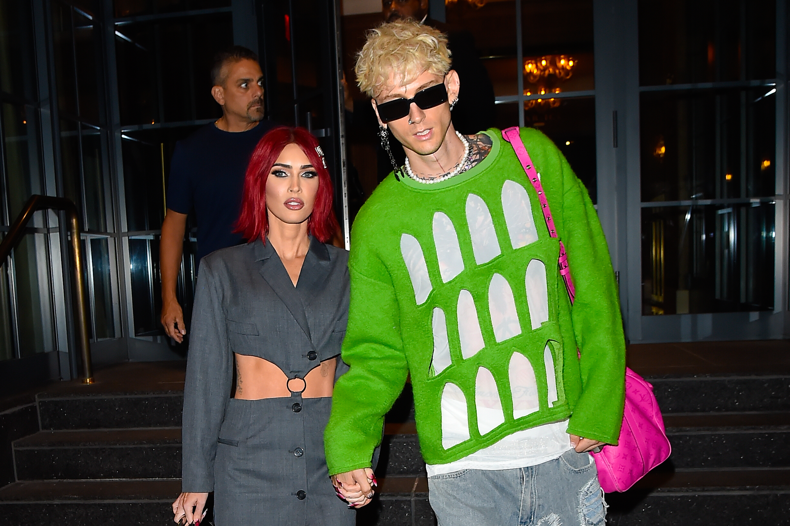 Megan Fox and Machine Gun Kelly holding hands and walking