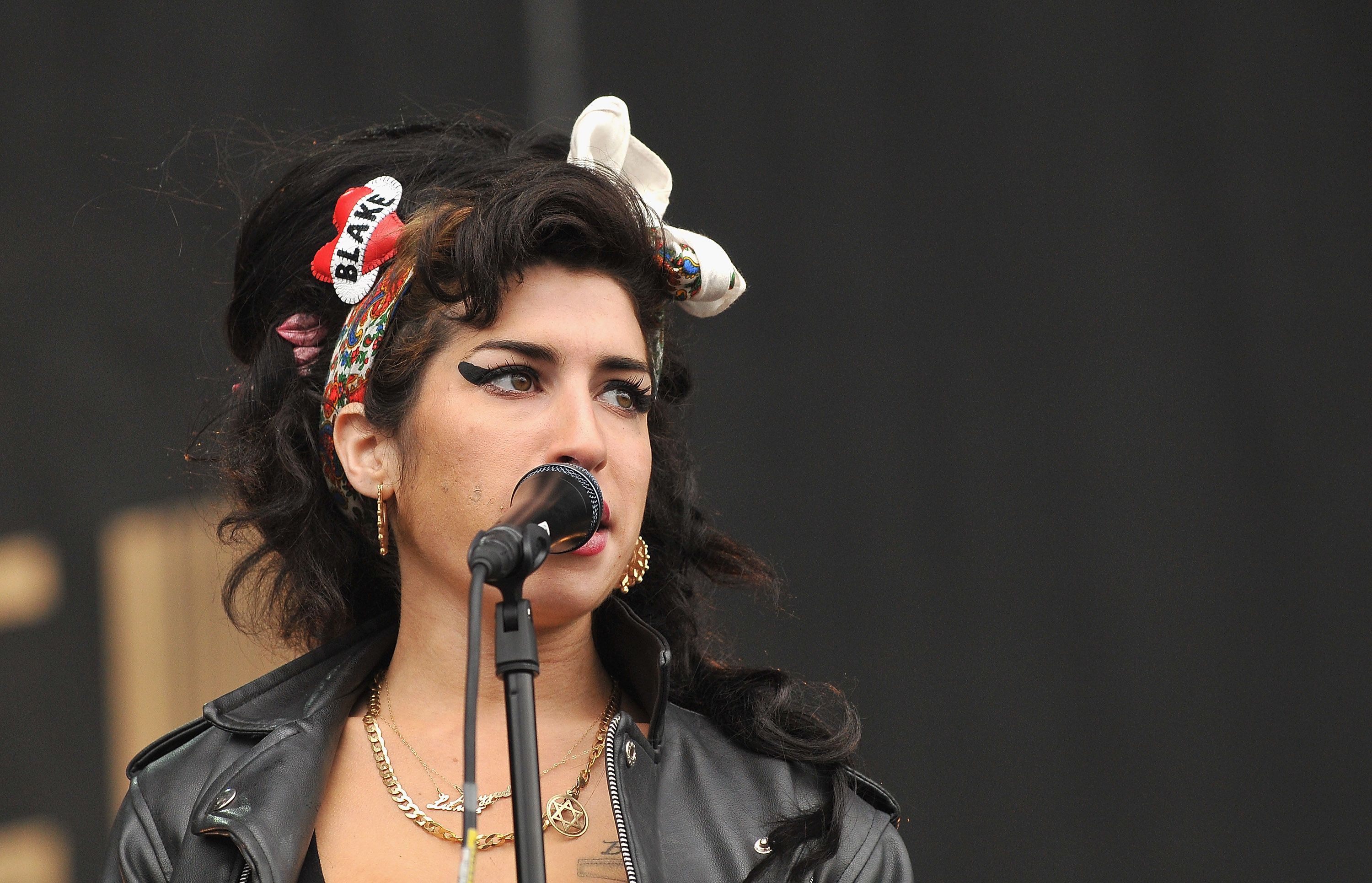 Amy Winehouse performing, with her signature beehive hairstyle and bold eyeliner