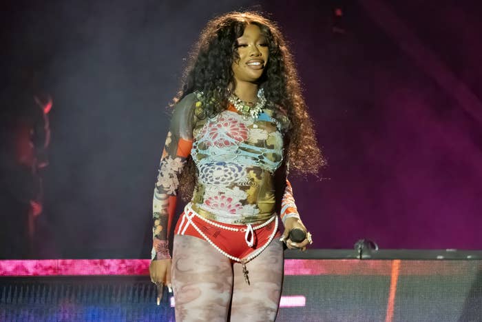 SZA performing on stage wearing a printed outfit with embellishments