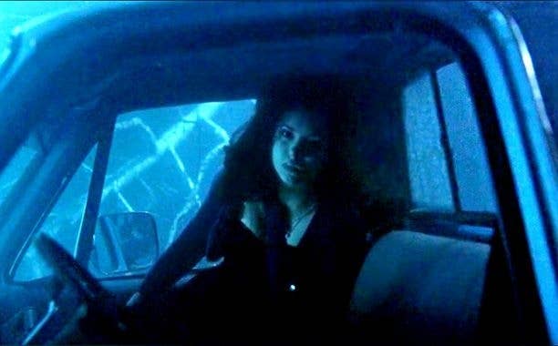 Elena underwater in a submerged car.