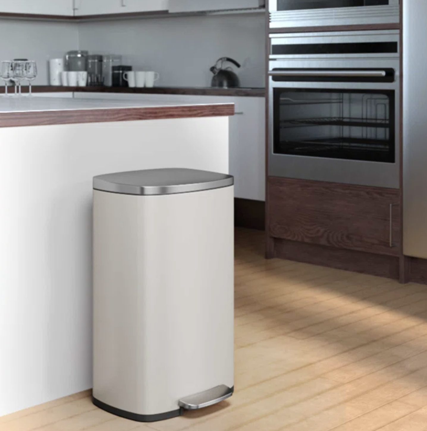 Stainless steel pedal trash can in a modern kitchen setting