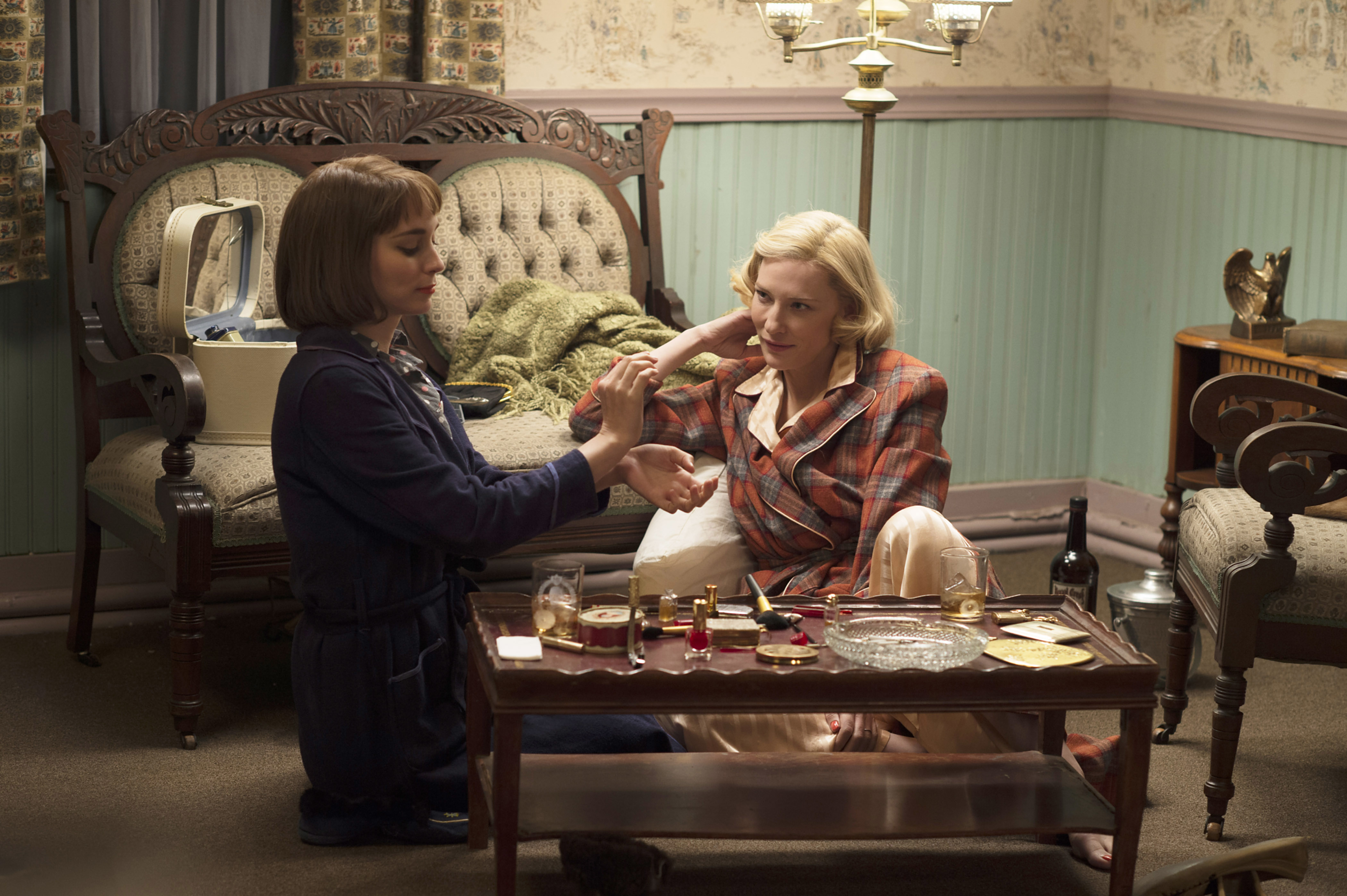in a scene, Rooney and Cate sitting on the floor of a room with vintage furniture, Cate gazing at Rooney