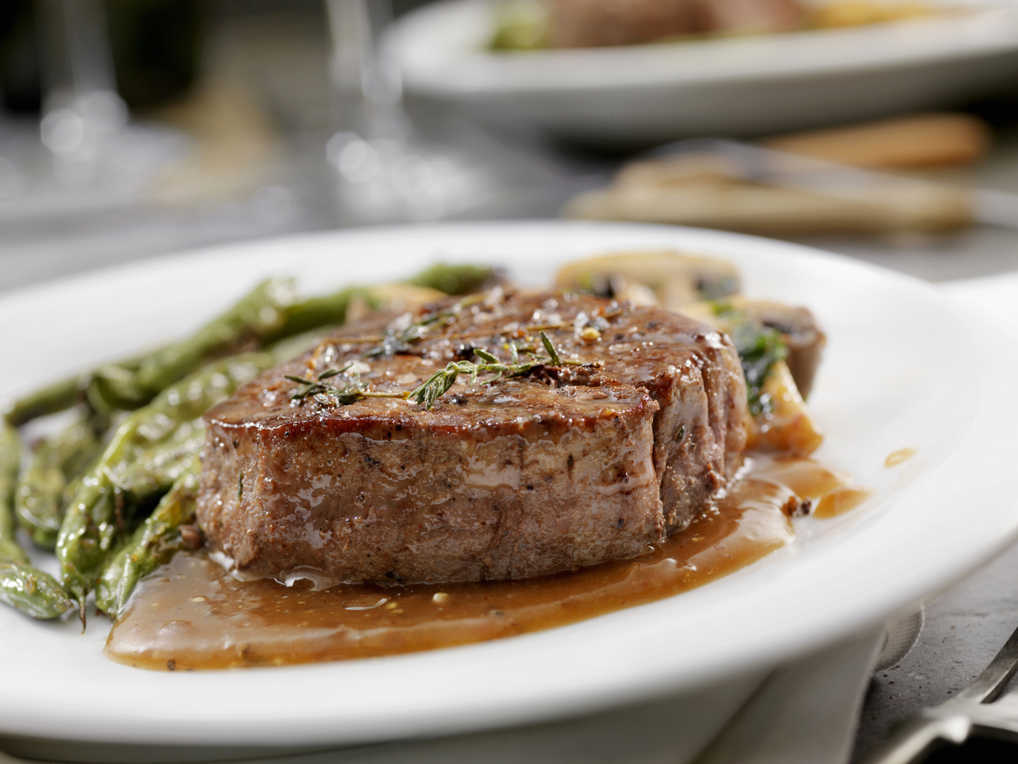 A grilled steak paired with asparagus on a plate, suggesting a family dinner idea