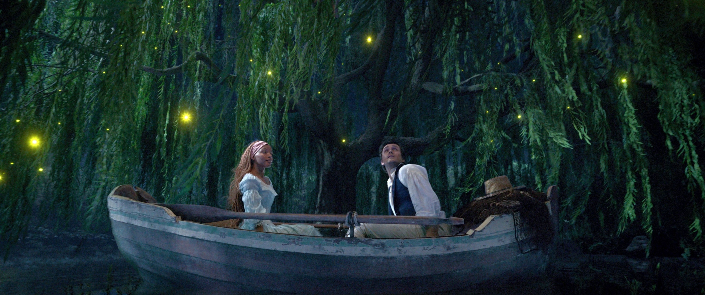 Ariel and Eric in a boat surrounded by lanterns in a scene from Tangled