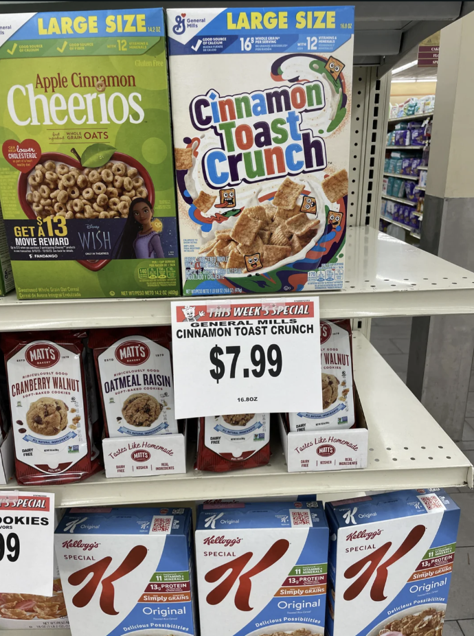 Grocery store shelf with Cinnamon Toast Crunch on sale for $7.99, surrounded by other cereals and products