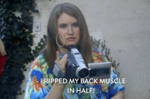 Person holding a camcorder with caption about back muscle injury