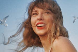 Taylor Swift smiles with a backdrop of the sky and birds in flight