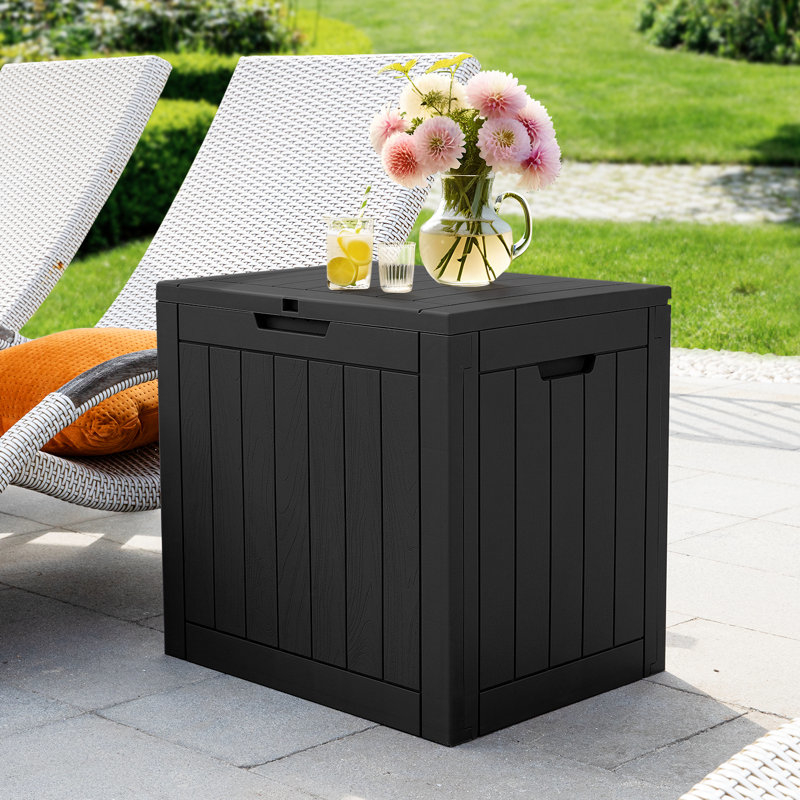 Outdoor plastic storage box with a vase of flowers and drinks on top, placed on a patio