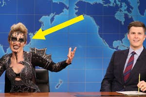 Kate McKinnon wearing a distinctive mask and costume, sitting next to Colin Jost at the SNL Weekend Update desk