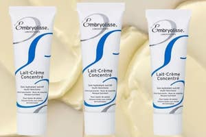 Three tubes of Embryolisse Lait-Crème Concentré moisturizer on a smooth surface