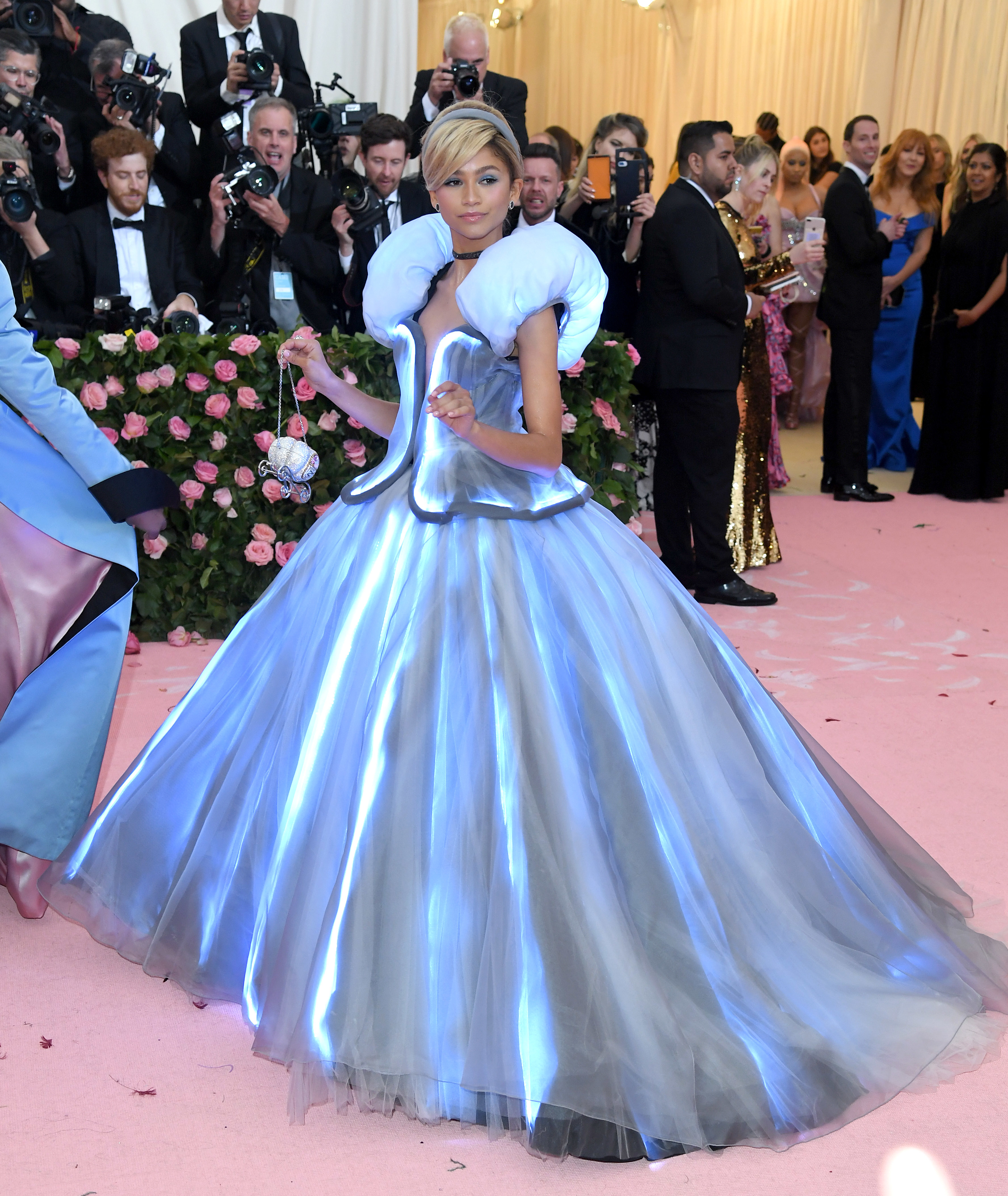 Woman in an avant-garde, puffed-sleeve gown at a gala event