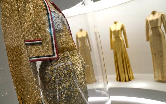 Gold sequined dresses on display, detail focus on beadwork and fabric texture