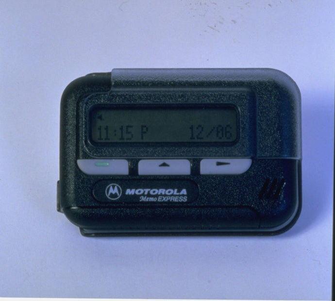 Motorola pager displaying time and date, related to communication in work environments