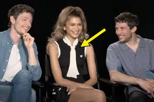 Zendaya, Mike Faist, and Josh O'Conner people sitting, central figure in black sleeveless top with white scarf, flanked by two smiling individuals