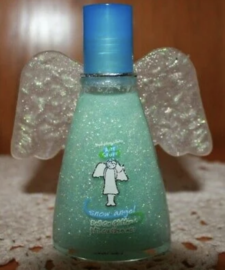 Glittery bottle with angel wing attachments and labeled &quot;Snow angel&quot; with a cartoon figure