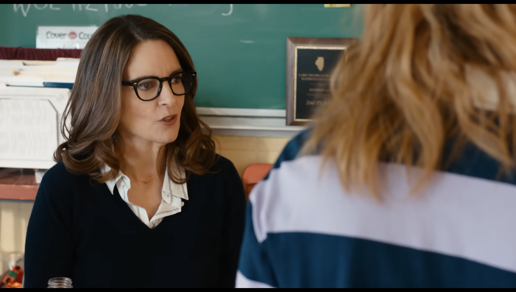 Tina Fey portraying a teacher speaking to a student in a classroom scene