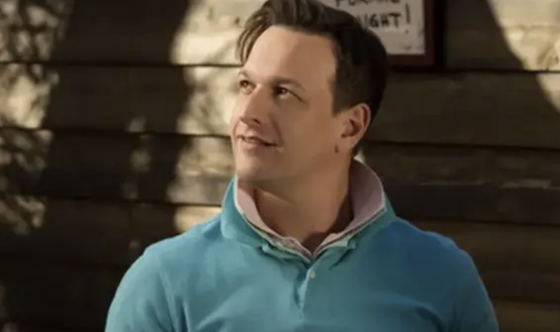 Closeup of Josh Charles with two polos on and the collars popped