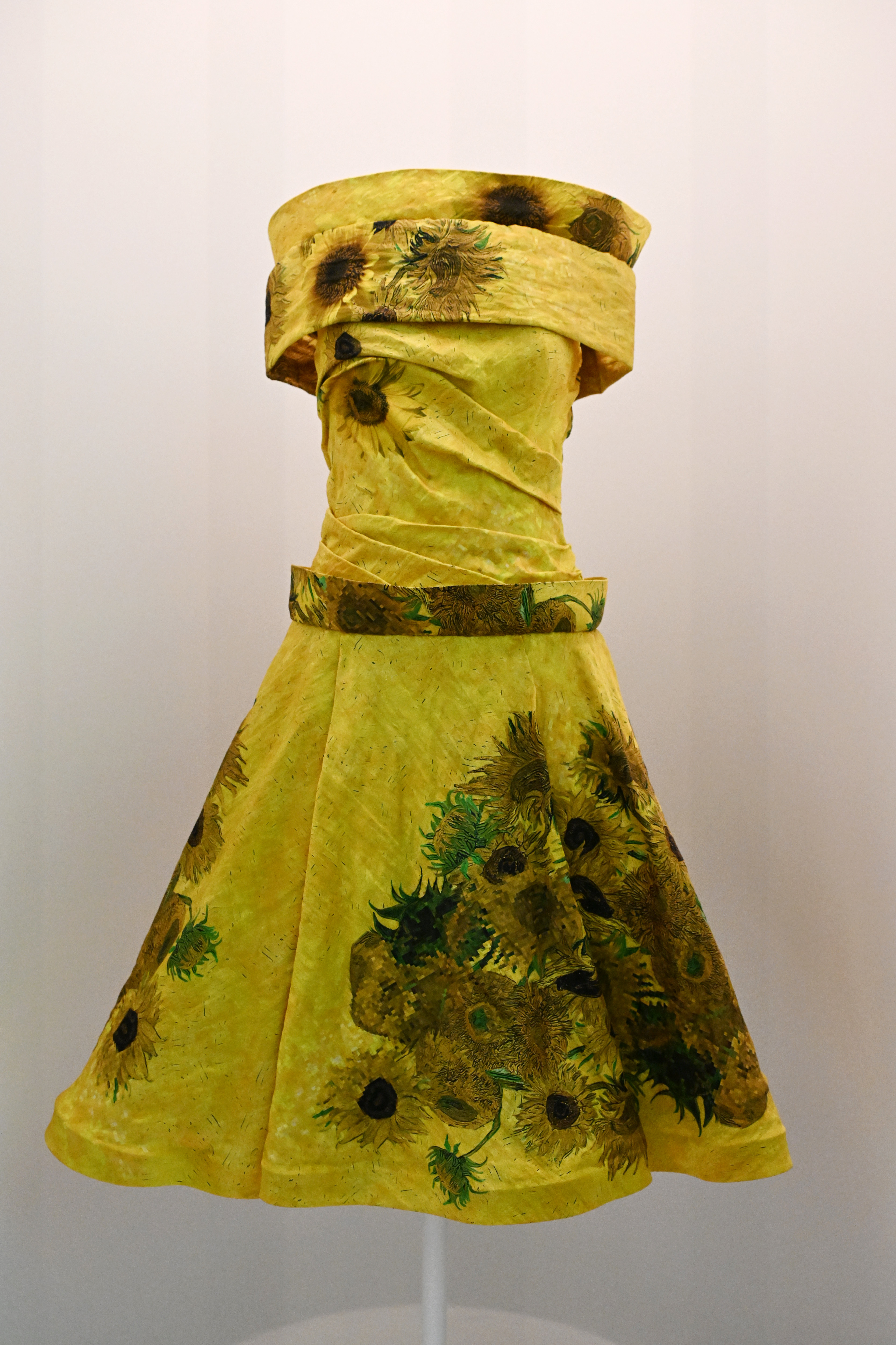 Vintage-style dress with sunflower print displayed on a mannequin