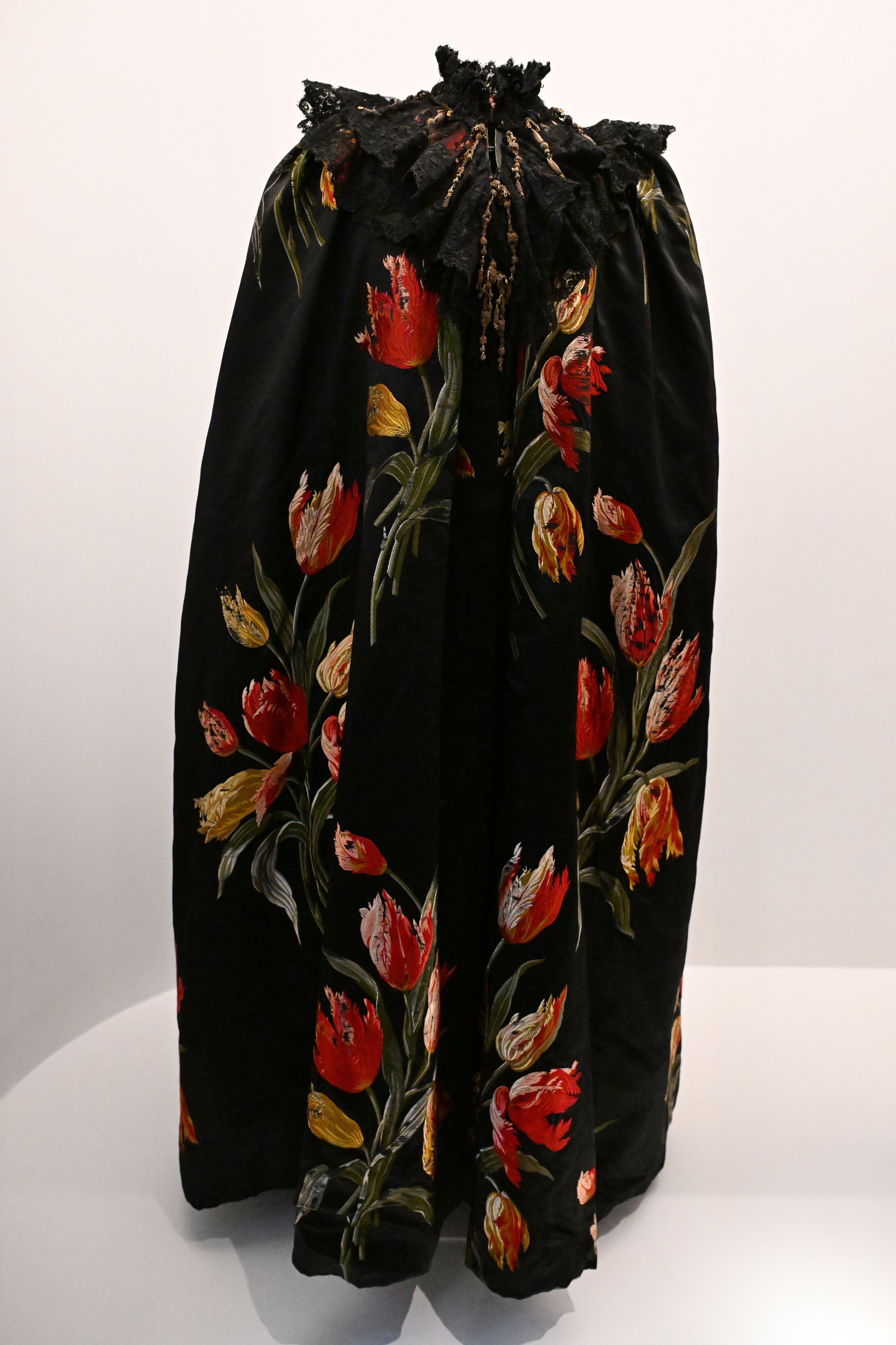 Black skirt with floral pattern on display, intricate lace at waist. No persons visible