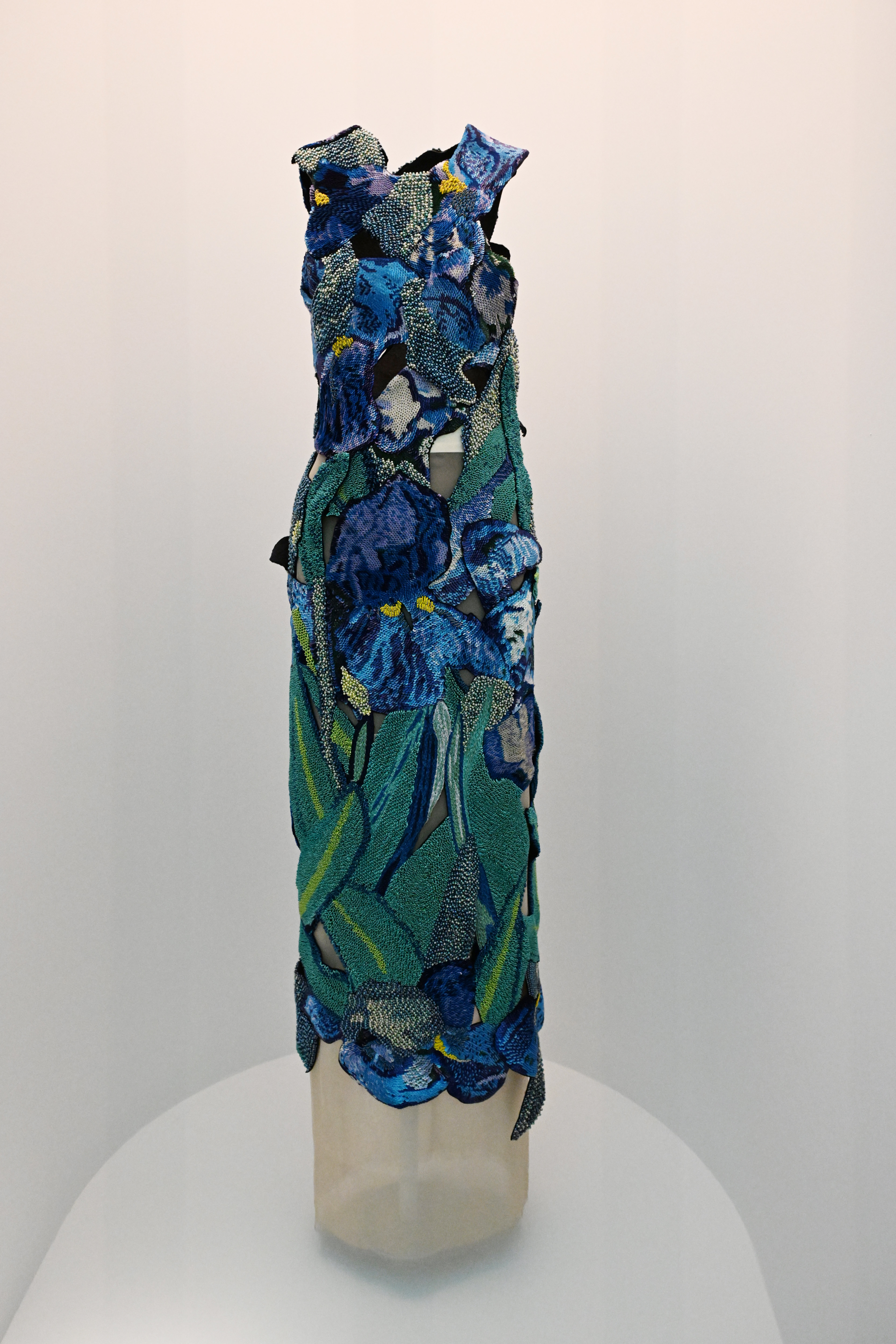 Mannequin displaying a floral embroidered gown with textured details