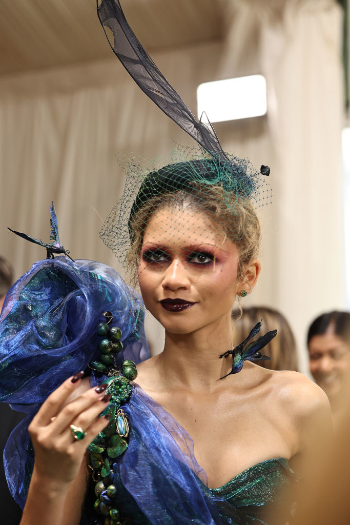 Zendaya in a tall feathered headpiece