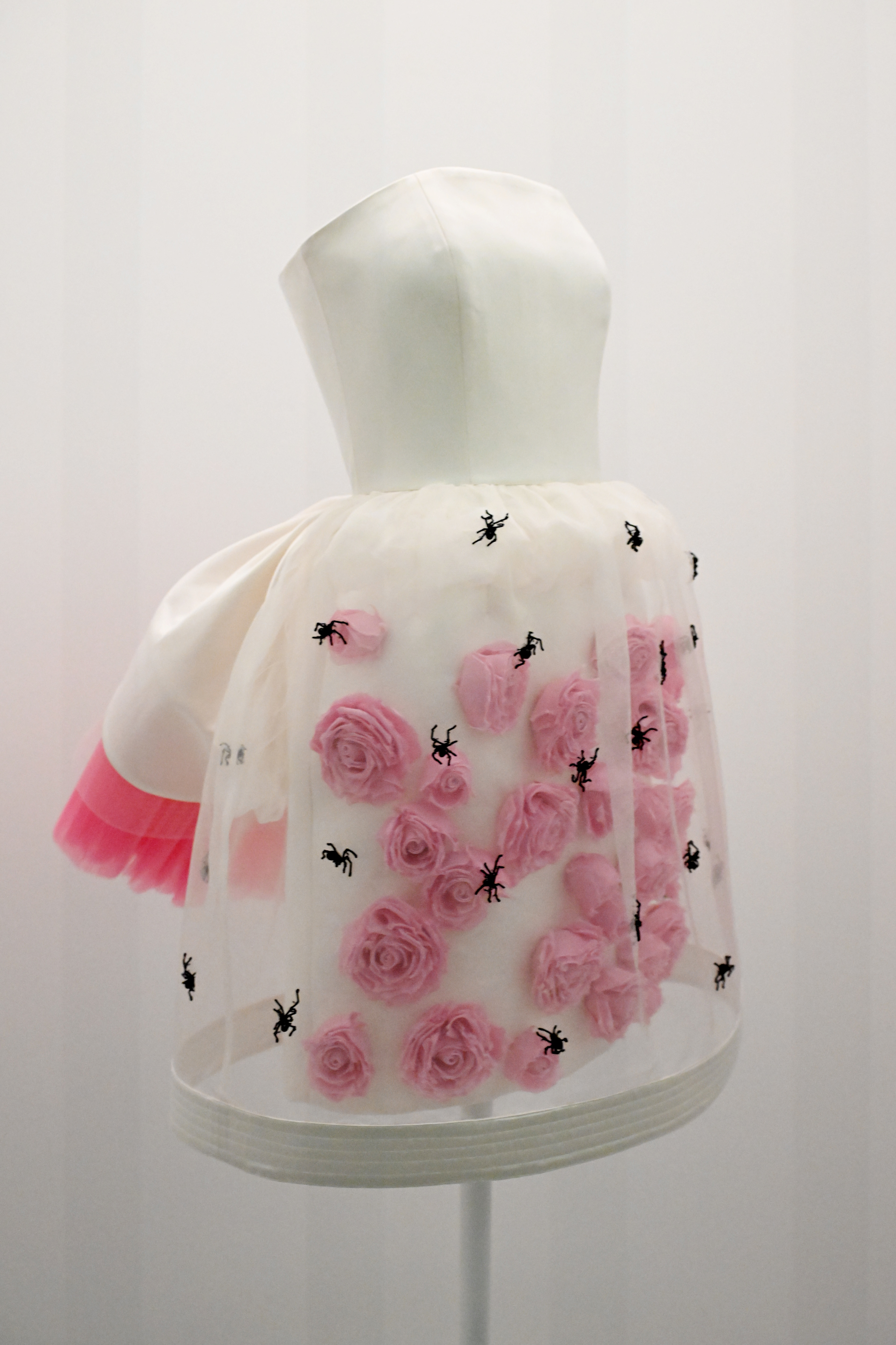 Mannequin displaying a dress with three-dimensional roses and spider embellishments