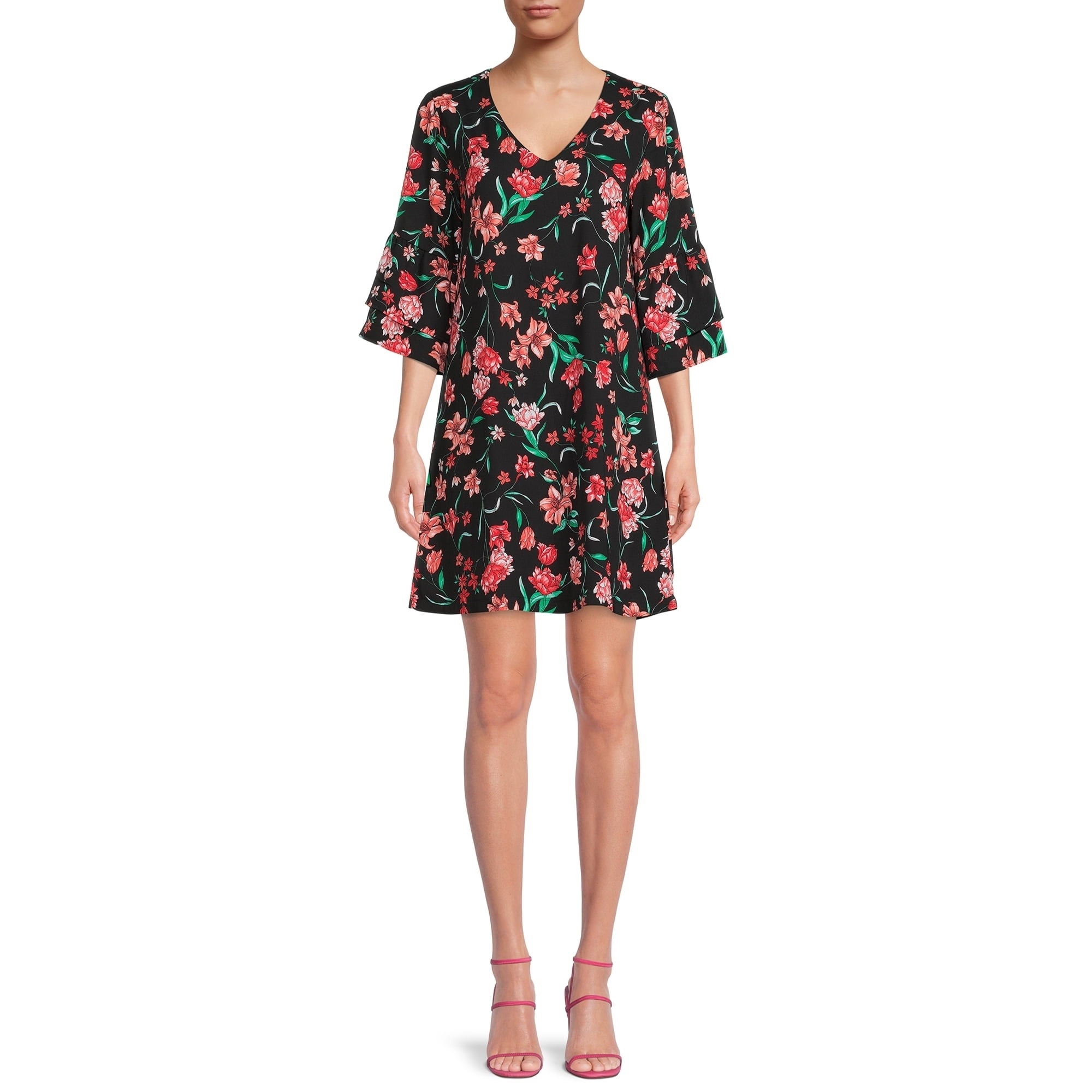 Person wearing a floral dress with a V-neck and ruffled sleeves, paired with pink strappy heels. Perfect for a spring wardrobe update