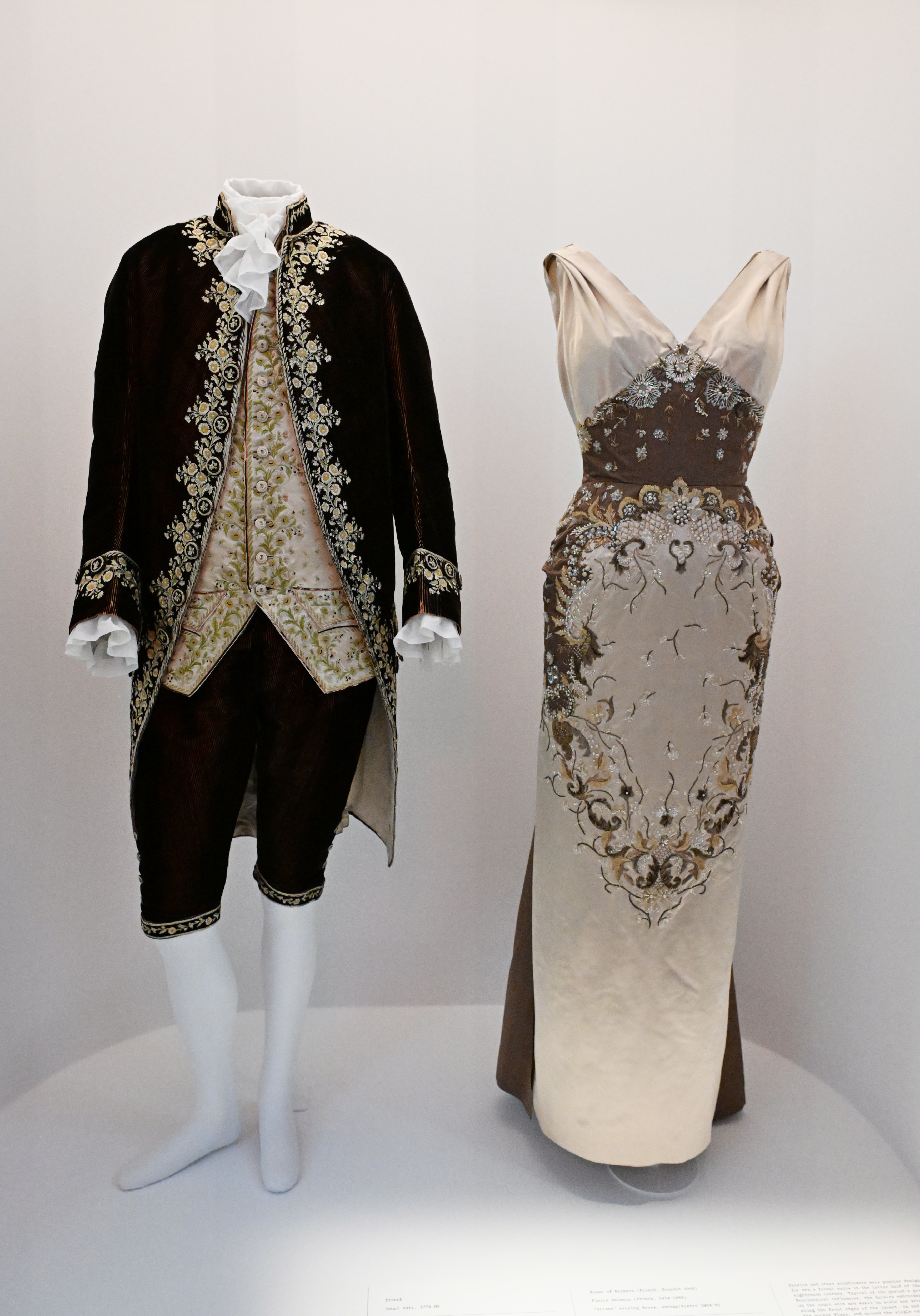 Historical male and female mannequins displaying ornate 18th-century-style costumes