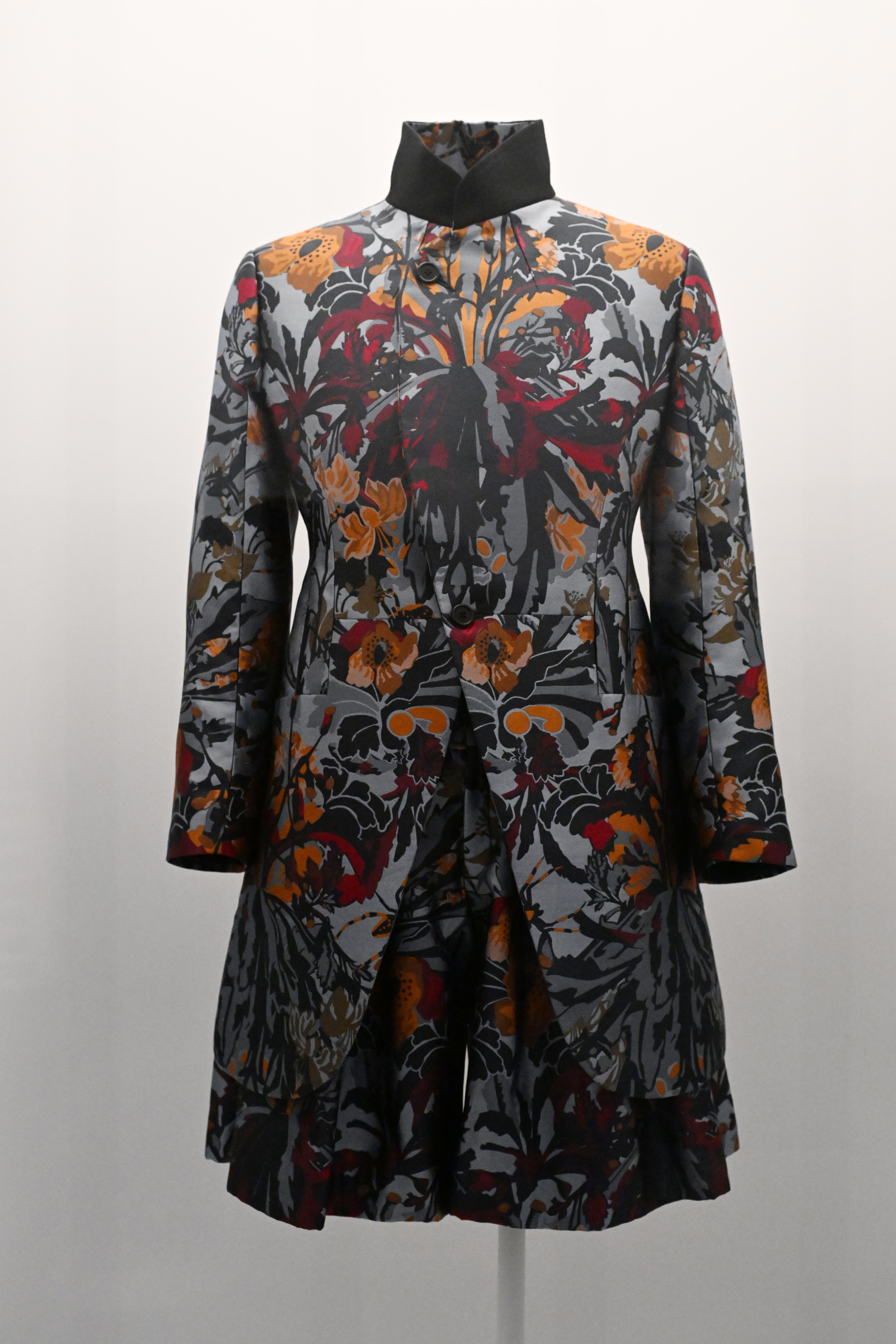 A patterned coat with a floral design on display