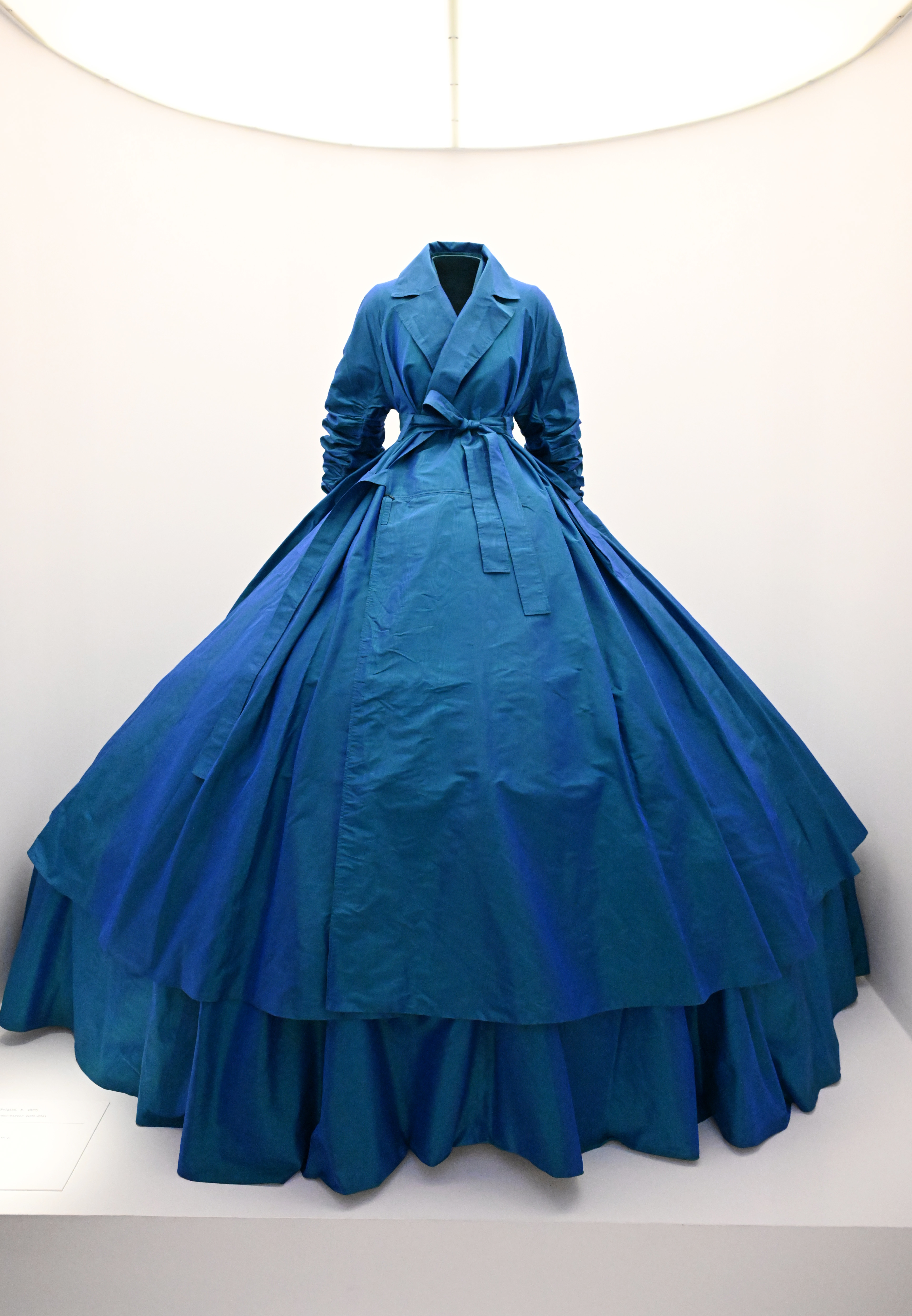 Elegant blue gown displayed on a mannequin with a voluminous skirt and fitted bodice